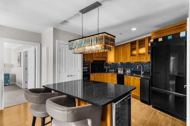 2881 Peachtree Rd NE Unit 1102, Atlanta, GA 30305 - kitchen with refrigerator, wine cooler, a sink, a chandelier, and light wood-style floors