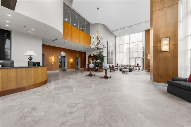 2881 Peachtree Rd NE Unit 1102, Atlanta, GA 30305 - reception featuring a towering ceiling, wood walls, and a chandelier