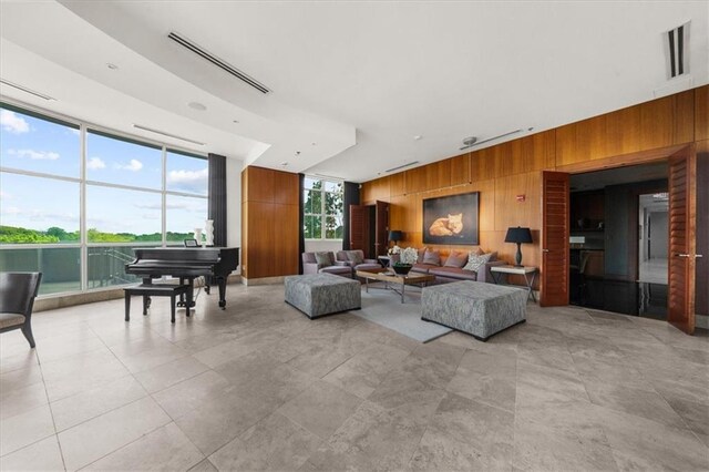 2881 Peachtree Rd NE Unit 1102, Atlanta, GA 30305 - living room featuring wood walls, expansive windows, and light tile patterned flooring