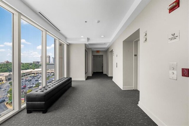 2881 Peachtree Rd NE Unit 1102, Atlanta, GA 30305 - corridor with carpet flooring, baseboards, elevator, recessed lighting, and a view of city