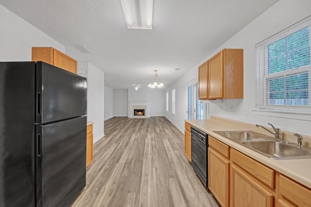 7459 Old Chapel, South Fulton, GA 30349 - kitchen with black appliances, light wood-style floors, a textured ceiling, a sink, and light countertops