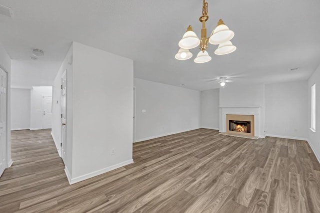 7459 Old Chapel, South Fulton, GA 30349 - unfurnished living room with wood finished floors, a warm lit fireplace, a chandelier, baseboards, and ceiling fan