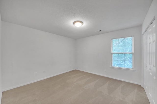 7459 Old Chapel, South Fulton, GA 30349 - unfurnished room featuring light carpet, baseboards, and a textured ceiling