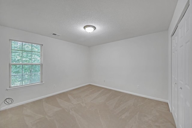 7459 Old Chapel, South Fulton, GA 30349 - empty room with baseboards, light carpet, and a textured ceiling