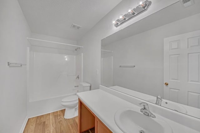 7459 Old Chapel, South Fulton, GA 30349 - bathroom with toilet, vanity, shower / tub combination, wood finished floors, and a textured ceiling