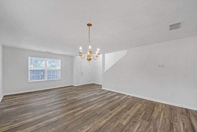 7459 Old Chapel, South Fulton, GA 30349 - spare room with a chandelier, dark wood-style floors, and baseboards