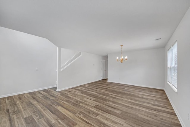7459 Old Chapel, South Fulton, GA 30349 - unfurnished living room with a chandelier, wood finished floors, and baseboards