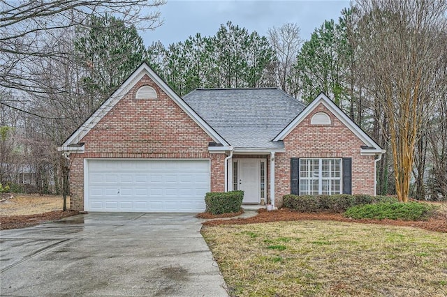 ranch-style home with brick siding, a front lawn, roof with shingles, a garage, and driveway