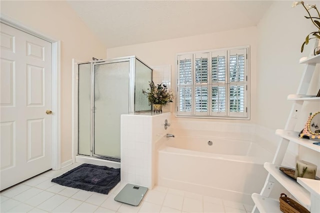 full bathroom with tile patterned flooring, a shower stall, a garden tub, and a textured ceiling