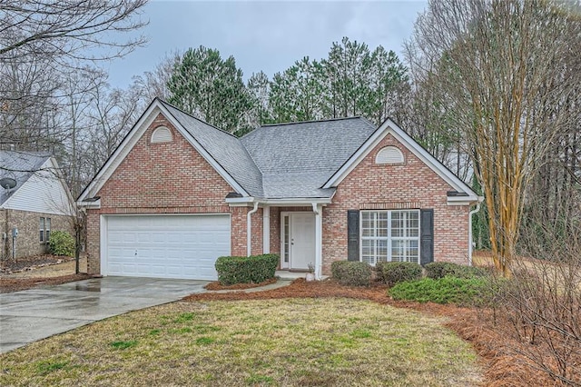 view of front facade featuring brick siding, an attached garage, a shingled roof, a front lawn, and driveway