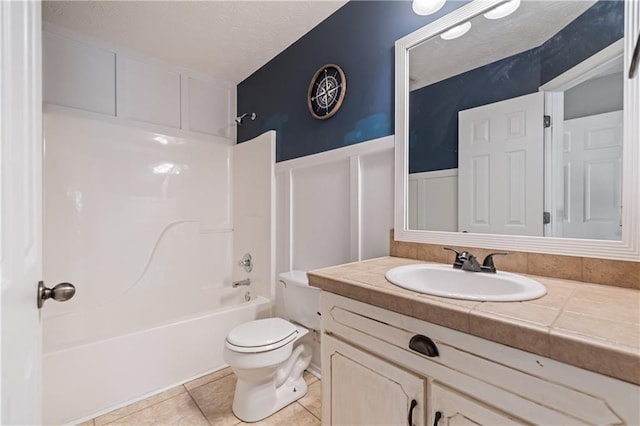 full bathroom with vanity, a wainscoted wall, tile patterned flooring, toilet, and shower / bathtub combination