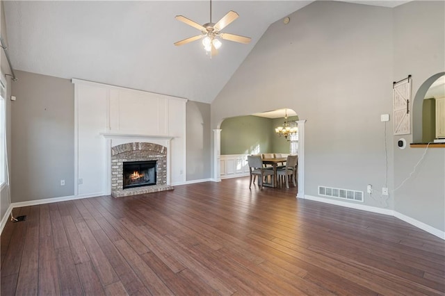 unfurnished living room with visible vents, baseboards, dark wood finished floors, and a ceiling fan