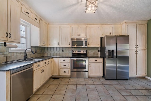 kitchen with tasteful backsplash, dark countertops, and appliances with stainless steel finishes