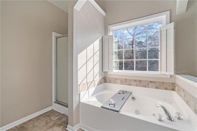 full bath with tile patterned floors, a tub with jets, a stall shower, and baseboards