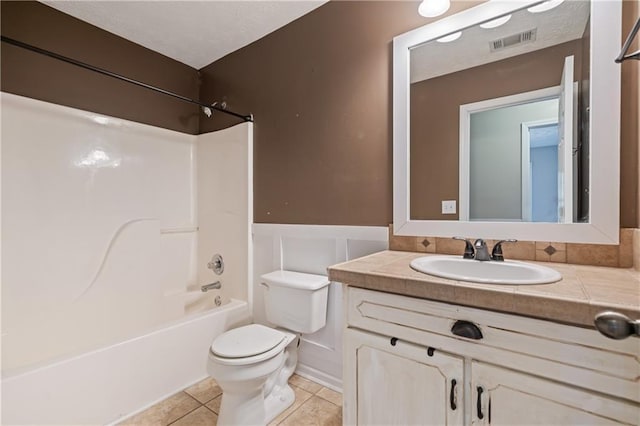 full bath with visible vents, toilet, wainscoting, tile patterned flooring, and vanity