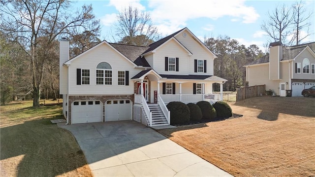 split level home with driveway, a porch, stairway, an attached garage, and a chimney