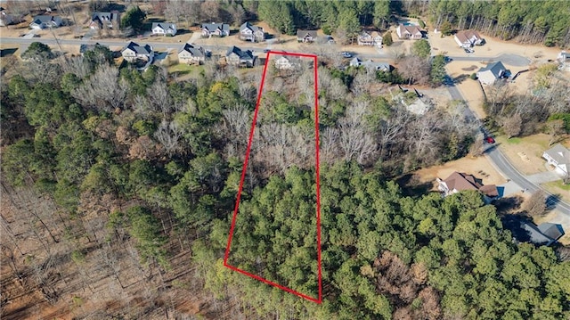 birds eye view of property with a wooded view