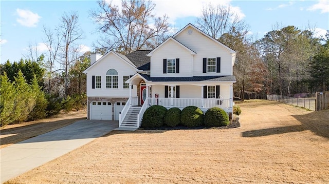 view of front facade with a porch, stairs, fence, concrete driveway, and a chimney