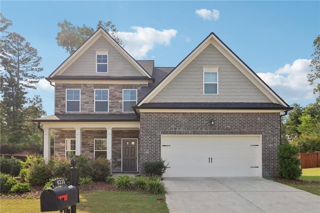 craftsman house featuring stone siding, brick siding, driveway, and fence