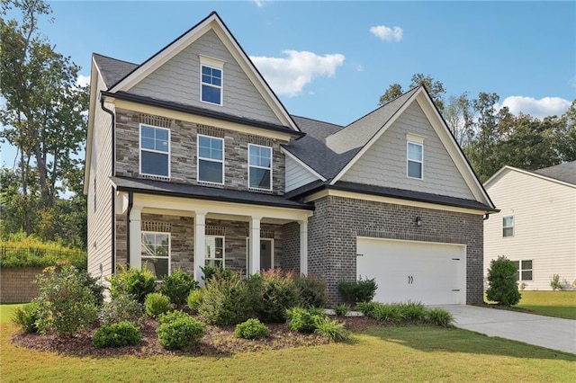 craftsman house featuring a garage, stone siding, concrete driveway, and a front yard