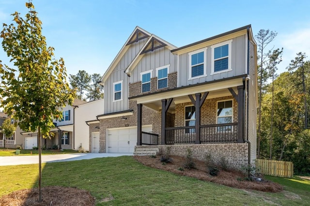 craftsman-style home with a front lawn, covered porch, and a garage