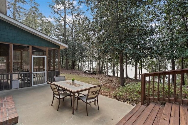 12 Rosalyn Rd, Georgetown, GA 39854 - wooden terrace featuring outdoor dining area, a patio, and a sunroom