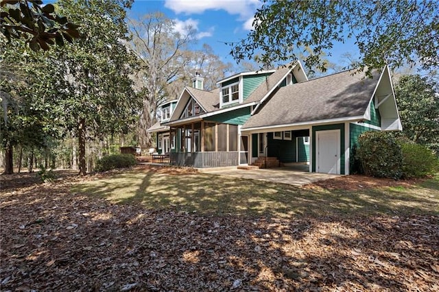 12 Rosalyn Rd, Georgetown, GA 39854 - back of property with a sunroom, a shingled roof, and a patio area