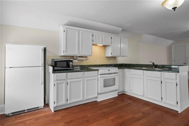 12 Rosalyn Rd, Georgetown, GA 39854 - kitchen with white appliances, a peninsula, dark countertops, white cabinetry, and a sink