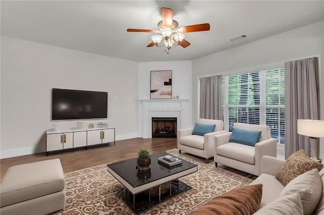 335 Pintail Ct, Suwanee, GA 30024 - living area with ceiling fan, wood finished floors, baseboards, and a fireplace