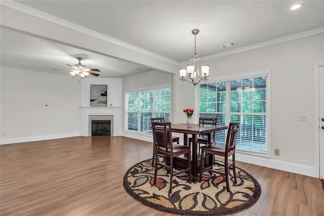 335 Pintail Ct, Suwanee, GA 30024 - dining room featuring wood finished floors, baseboards, a chandelier, a fireplace, and ornamental molding