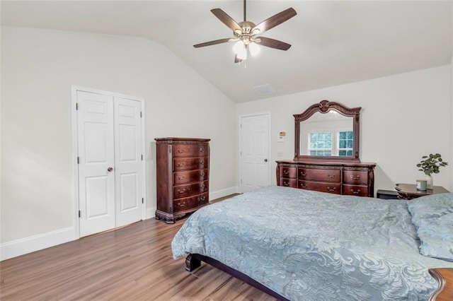 335 Pintail Ct, Suwanee, GA 30024 - bedroom featuring wood finished floors, vaulted ceiling, a ceiling fan, and baseboards