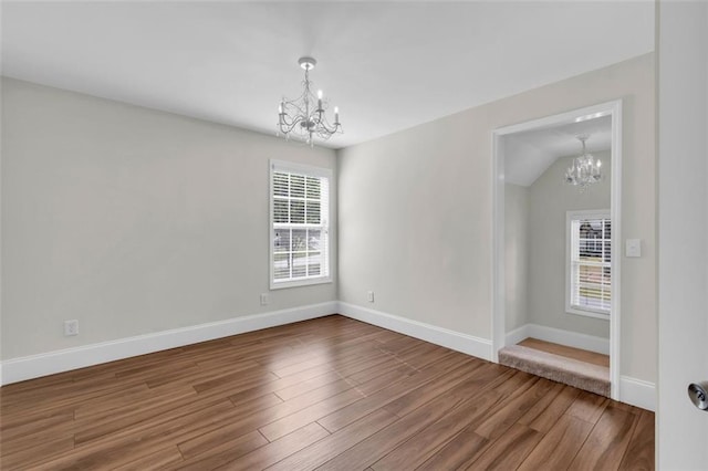 335 Pintail Ct, Suwanee, GA 30024 - unfurnished room featuring a chandelier, wood finished floors, and baseboards
