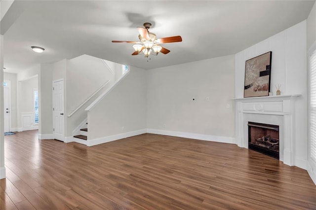 335 Pintail Ct, Suwanee, GA 30024 - unfurnished living room featuring a ceiling fan, stairway, wood finished floors, a fireplace, and baseboards