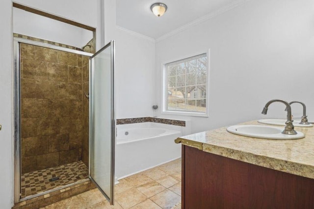 full bathroom featuring a garden tub, double vanity, ornamental molding, a stall shower, and a sink
