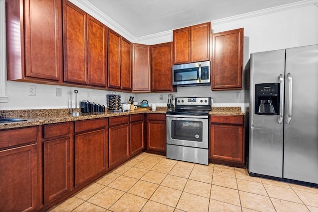 kitchen featuring dark stone counters, stainless steel appliances, light tile patterned flooring, and crown molding