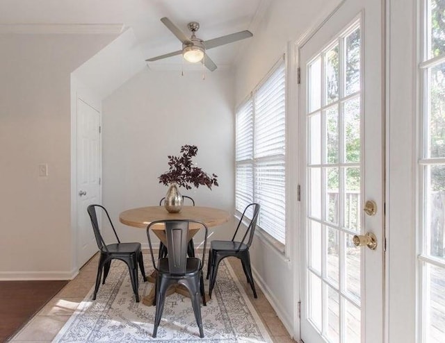 dining space with ceiling fan and baseboards