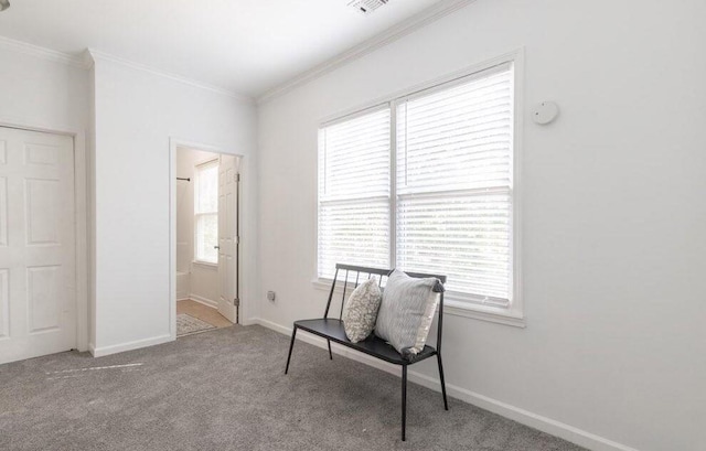 living area with ornamental molding, light carpet, and baseboards