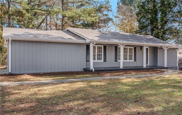 ranch-style house with a porch and a front yard