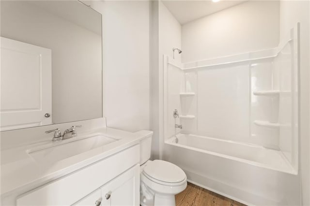 7127 Brushwood Bnd, Lithonia, GA 30058 - bathroom with washtub / shower combination, wood finished floors, vanity, and toilet