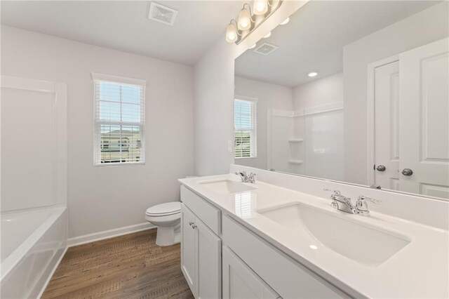 7127 Brushwood Bnd, Lithonia, GA 30058 - full bath with toilet, a sink, and plenty of natural light