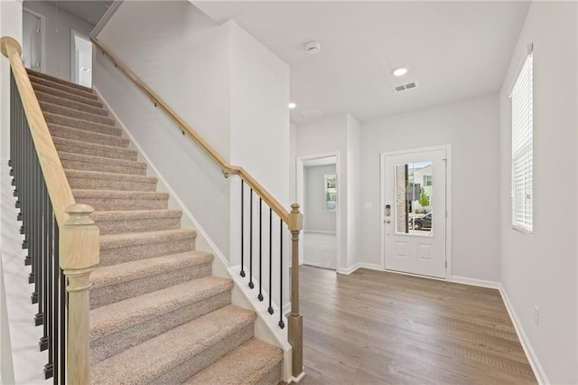 7127 Brushwood Bnd, Lithonia, GA 30058 - foyer entrance with recessed lighting, wood finished floors, stairs, baseboards, and visible vents
