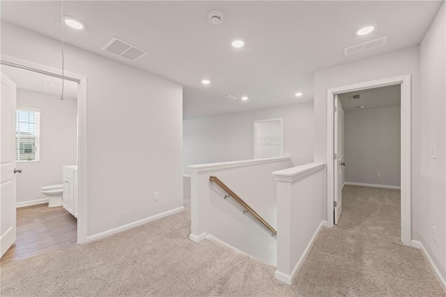 7127 Brushwood Bnd, Lithonia, GA 30058 - hallway with visible vents, attic access, an upstairs landing, and light colored carpet