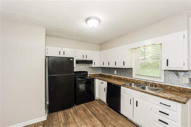 kitchen featuring sink, black appliances, white cabinets, dark hardwood / wood-style flooring, and dark stone counters