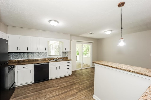 kitchen featuring sink, black appliances, dark hardwood / wood-style flooring, pendant lighting, and white cabinets