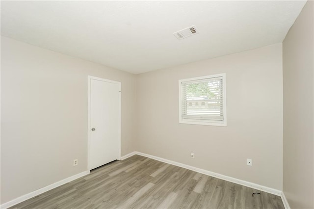 spare room with light hardwood / wood-style floors