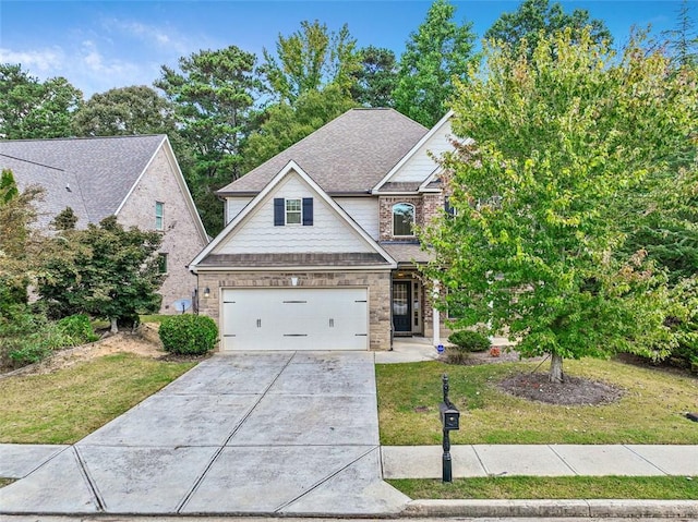 view of front of property featuring a front yard and a garage