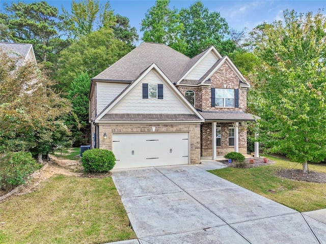 craftsman-style house featuring a garage and a front yard