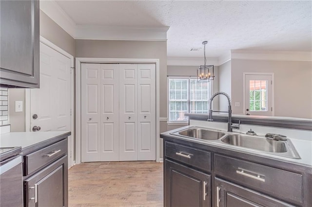 206 Belmont Dr, Monroe, GA 30655 - kitchen featuring a sink, ornamental molding, light wood-style flooring, a textured ceiling, and a chandelier