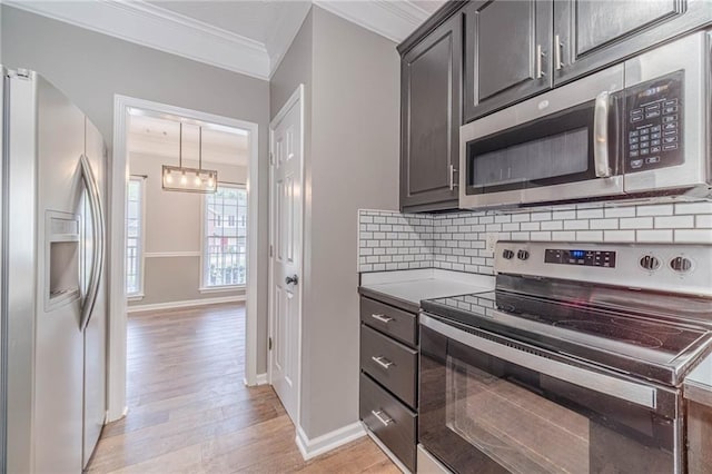 206 Belmont Dr, Monroe, GA 30655 - kitchen with appliances with stainless steel finishes, ornamental molding, light wood-style floors, decorative backsplash, and baseboards