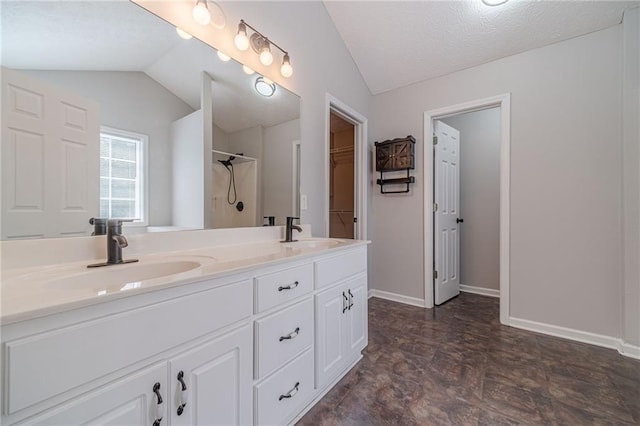 206 Belmont Dr, Monroe, GA 30655 - full bathroom with vaulted ceiling, a spacious closet, double vanity, a shower, and baseboards